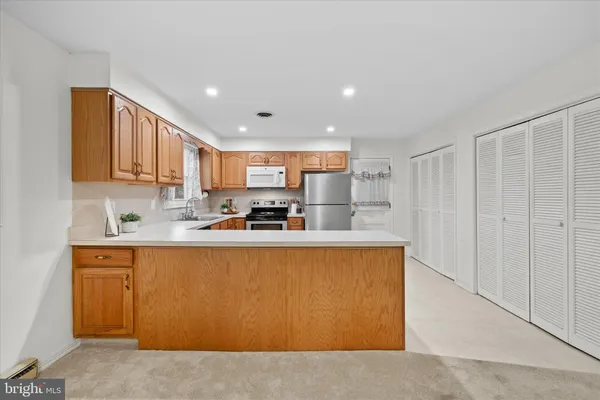 a kitchen with stainless steel appliances granite countertop a refrigerator sink and cabinets