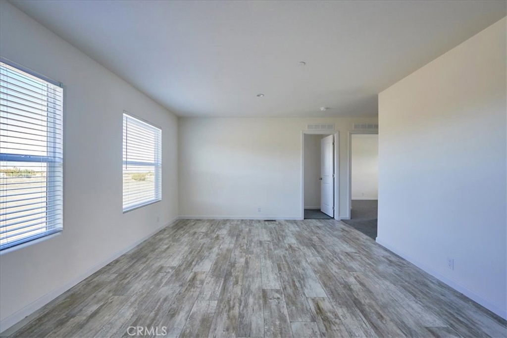 11475 Descanso Road Pinon Hills, CA 92372 - Photo 16 of 35 an empty room with wooden floor and windows