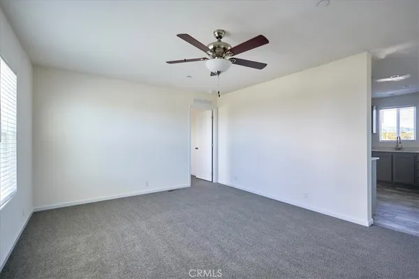 a view of room with window and ceiling fan