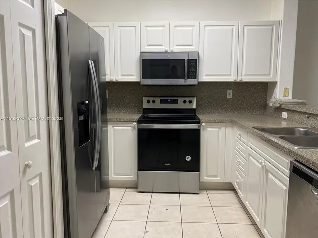 a kitchen with a stove and a refrigerator