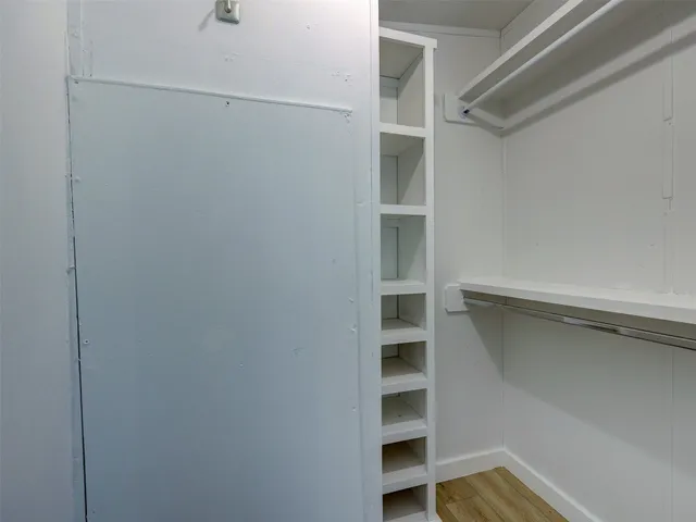 a view of a room with wooden floor