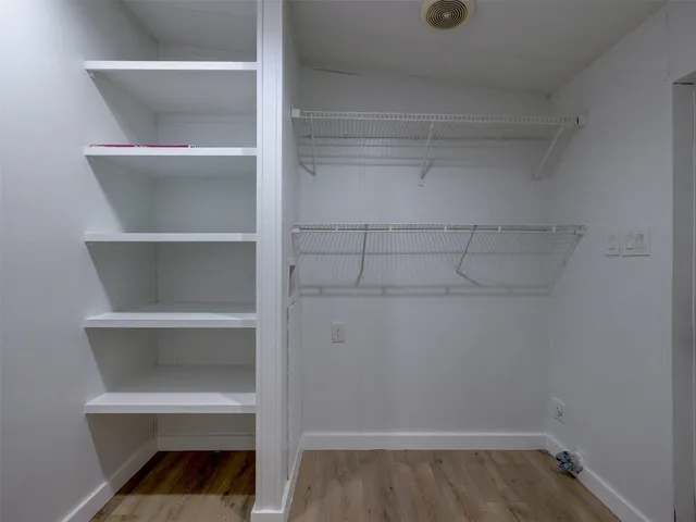 a view of a kitchen with a sink and a refrigerator
