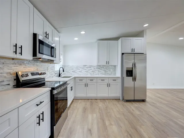 wooden floor in an empty room with a bathroom