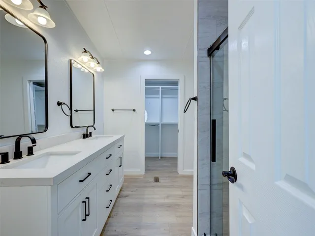 an empty room with closet and windows