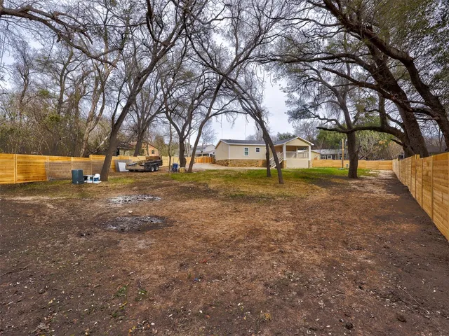 a view of backyard with large trees