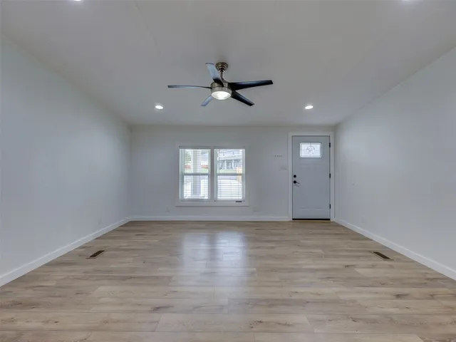 a view of kitchen with windows and refrigerator