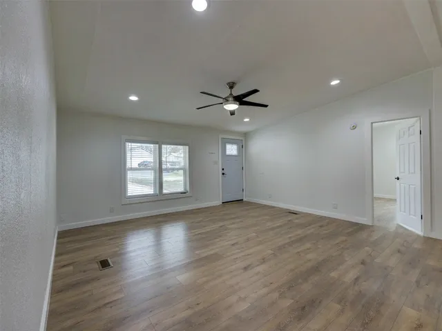 a kitchen with white cabinets and refrigerator