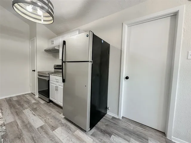 a view of a kitchen from the hallway