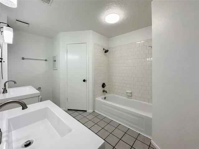 a spacious bathroom with a sink mirror and toilet