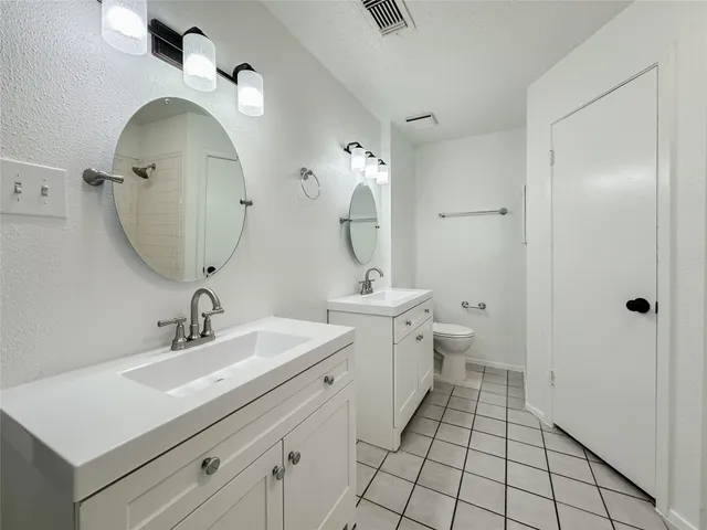a view of bathroom with dual sinks