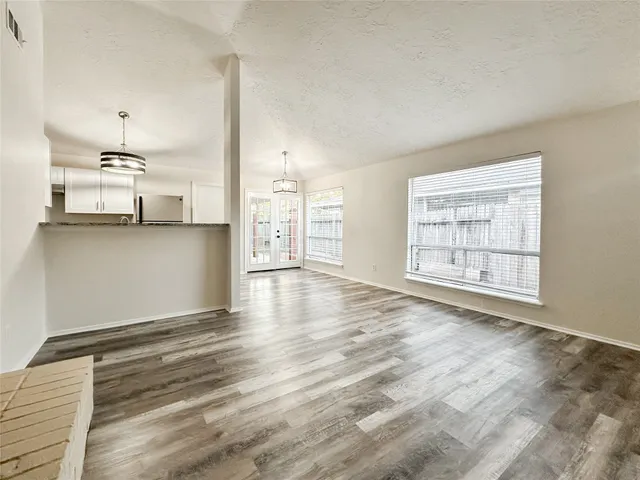 a view of a kitchen with wooden floor and a sink