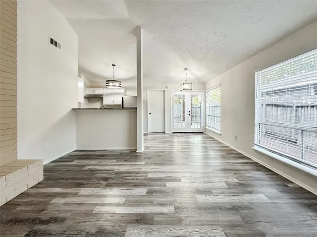 a view of a kitchen and an empty room