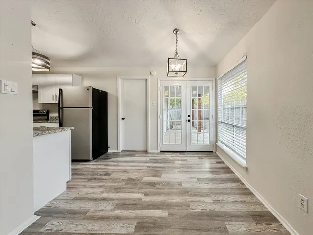 a kitchen with stainless steel appliances a stove a refrigerator and cabinets