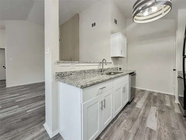 a kitchen with a refrigerator and a sink