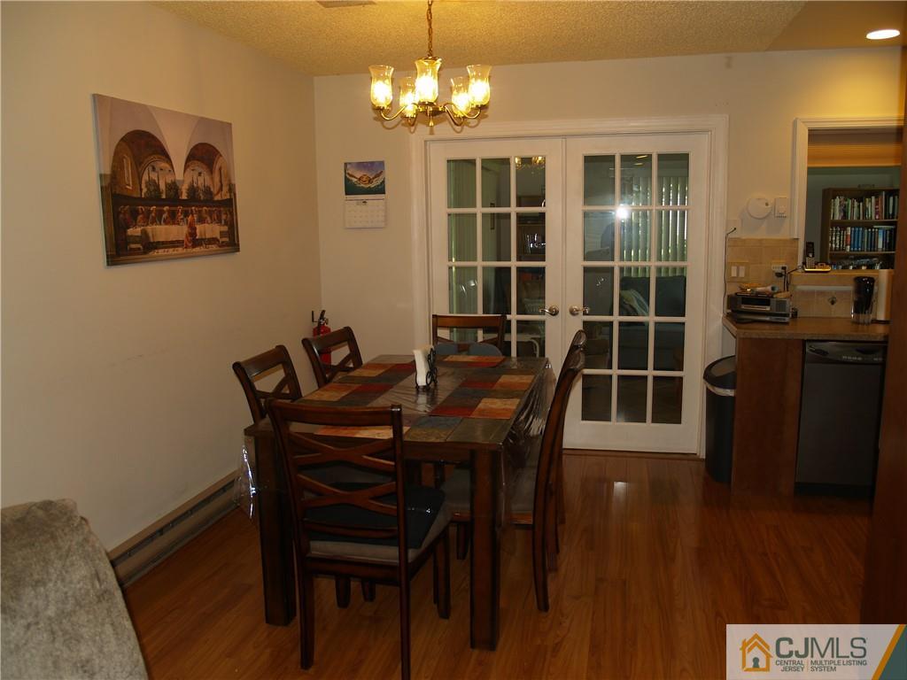 504 A Belford Road, Unit A Monroe Township, NJ 08831 - Photo 12 of 42 a view of a dining room with furniture and wooden floor