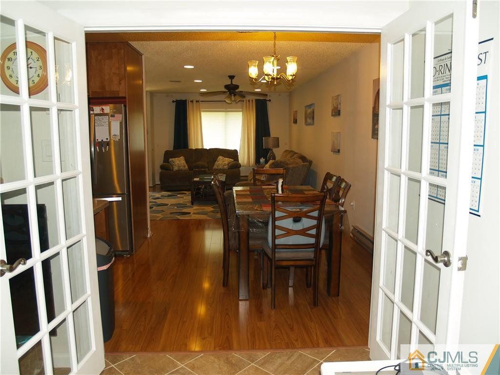 504 A Belford Road, Unit A Monroe Township, NJ 08831 - Photo 13 of 42 a view of a dining room with furniture and wooden floor