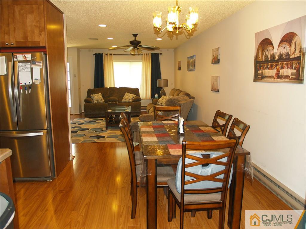 504 A Belford Road, Unit A Monroe Township, NJ 08831 - Photo 14 of 42 a view of a dining room with furniture and a chandelier
