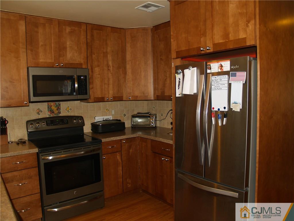 504 A Belford Road, Unit A Monroe Township, NJ 08831 - Photo 16 of 42 a kitchen with a refrigerator stove and microwave