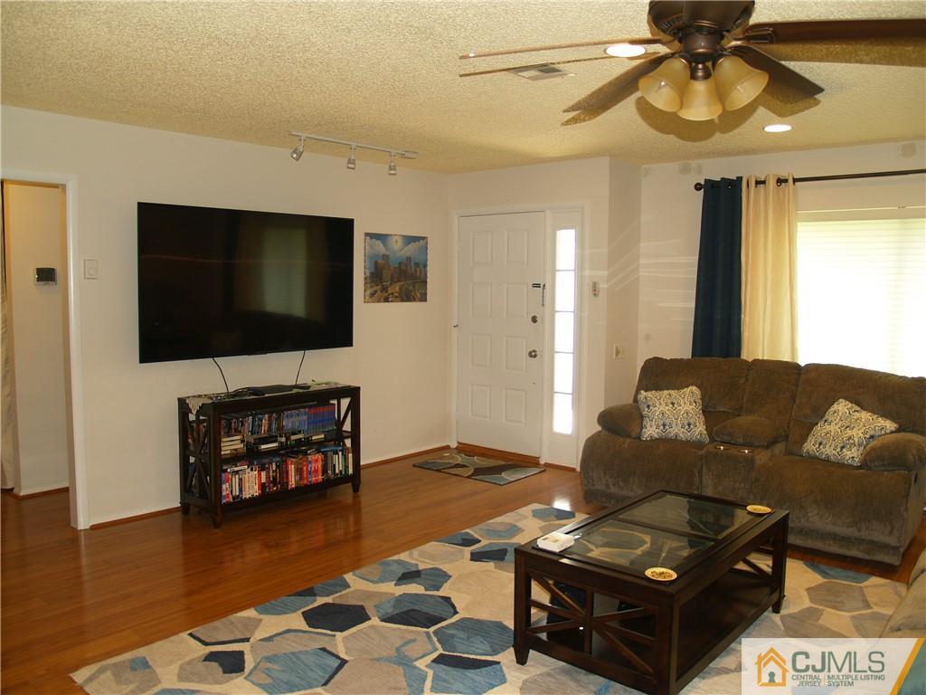 504 A Belford Road, Unit A Monroe Township, NJ 08831 - Photo 24 of 42 a living room with furniture and a flat screen tv