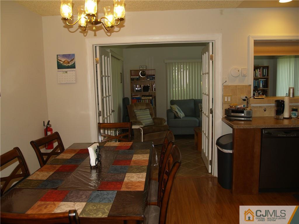 504 A Belford Road, Unit A Monroe Township, NJ 08831 - Photo 25 of 42 a view of a dining room with furniture and wooden floor