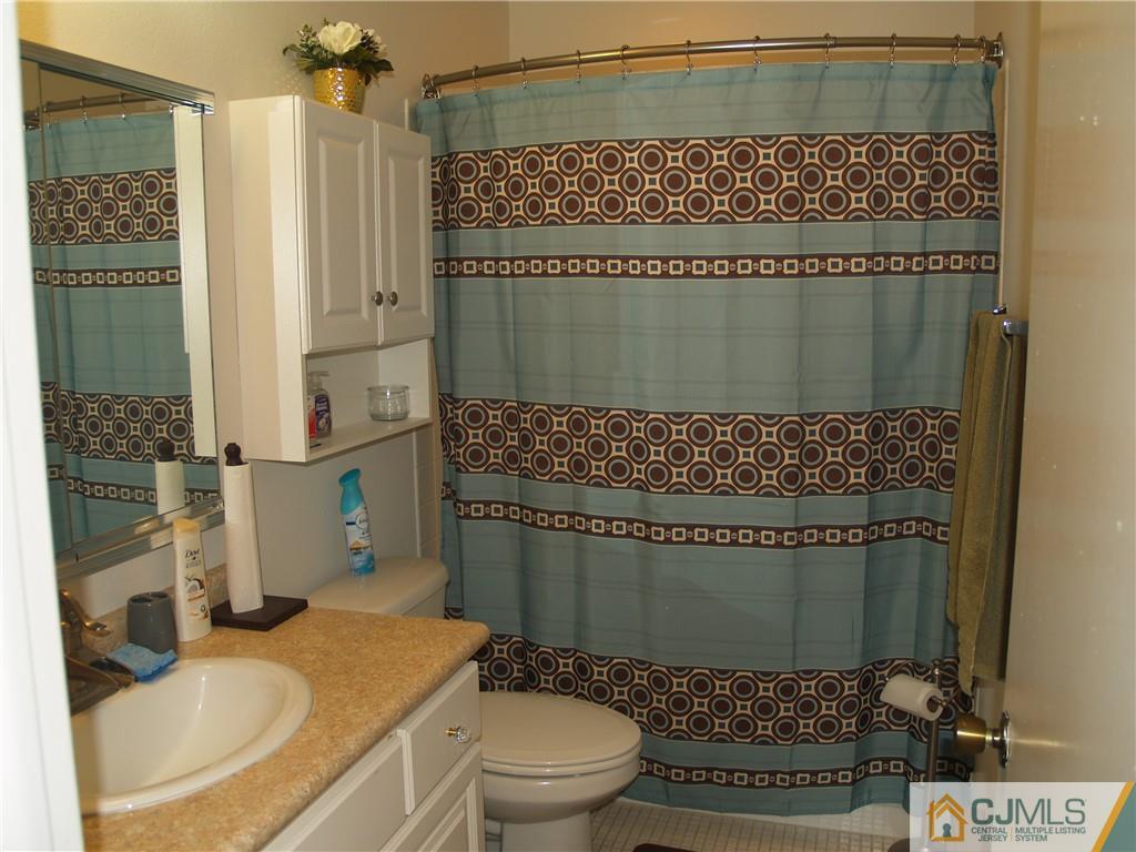504 A Belford Road, Unit A Monroe Township, NJ 08831 - Photo 26 of 42 a bathroom with a sink a toilet and shower