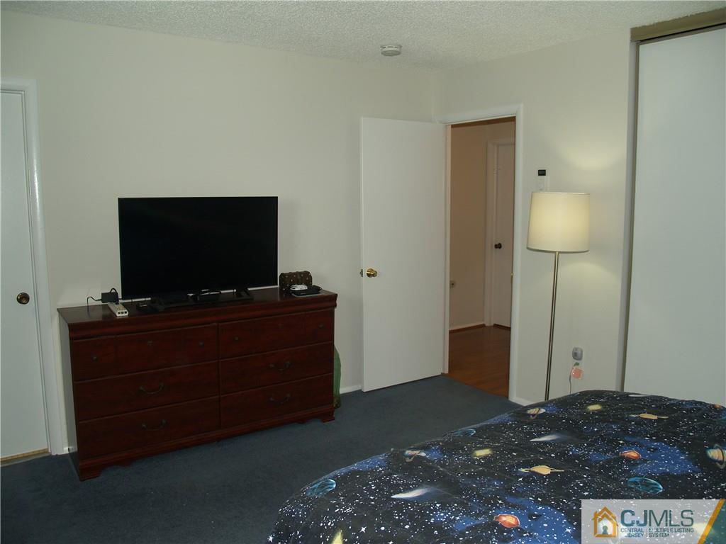 504 A Belford Road, Unit A Monroe Township, NJ 08831 - Photo 29 of 42 a living room with furniture and a flat screen tv
