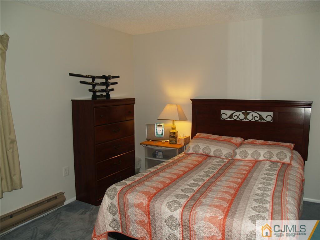 504 A Belford Road, Unit A Monroe Township, NJ 08831 - Photo 34 of 42 a bedroom with a bed and a dresser