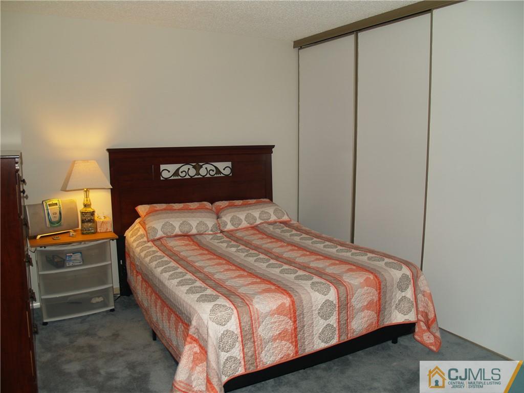 504 A Belford Road, Unit A Monroe Township, NJ 08831 - Photo 35 of 42 a bedroom with a bed and painting on the wall