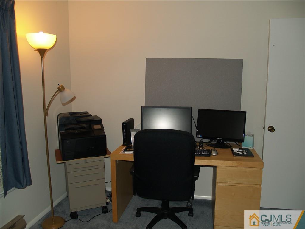 504 A Belford Road, Unit A Monroe Township, NJ 08831 - Photo 38 of 42 a view of workspace with chair and wooden floor