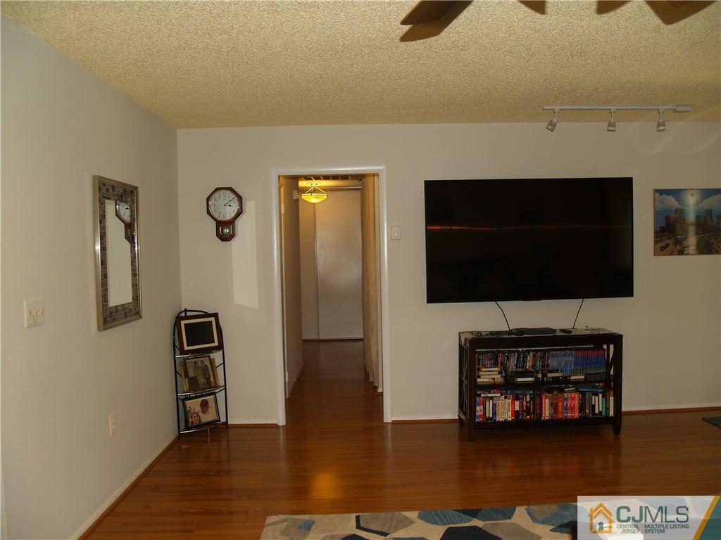 504 A Belford Road, Unit A Monroe Township, NJ 08831 - Photo 9 of 42 a living room with a flat screen tv and a fireplace