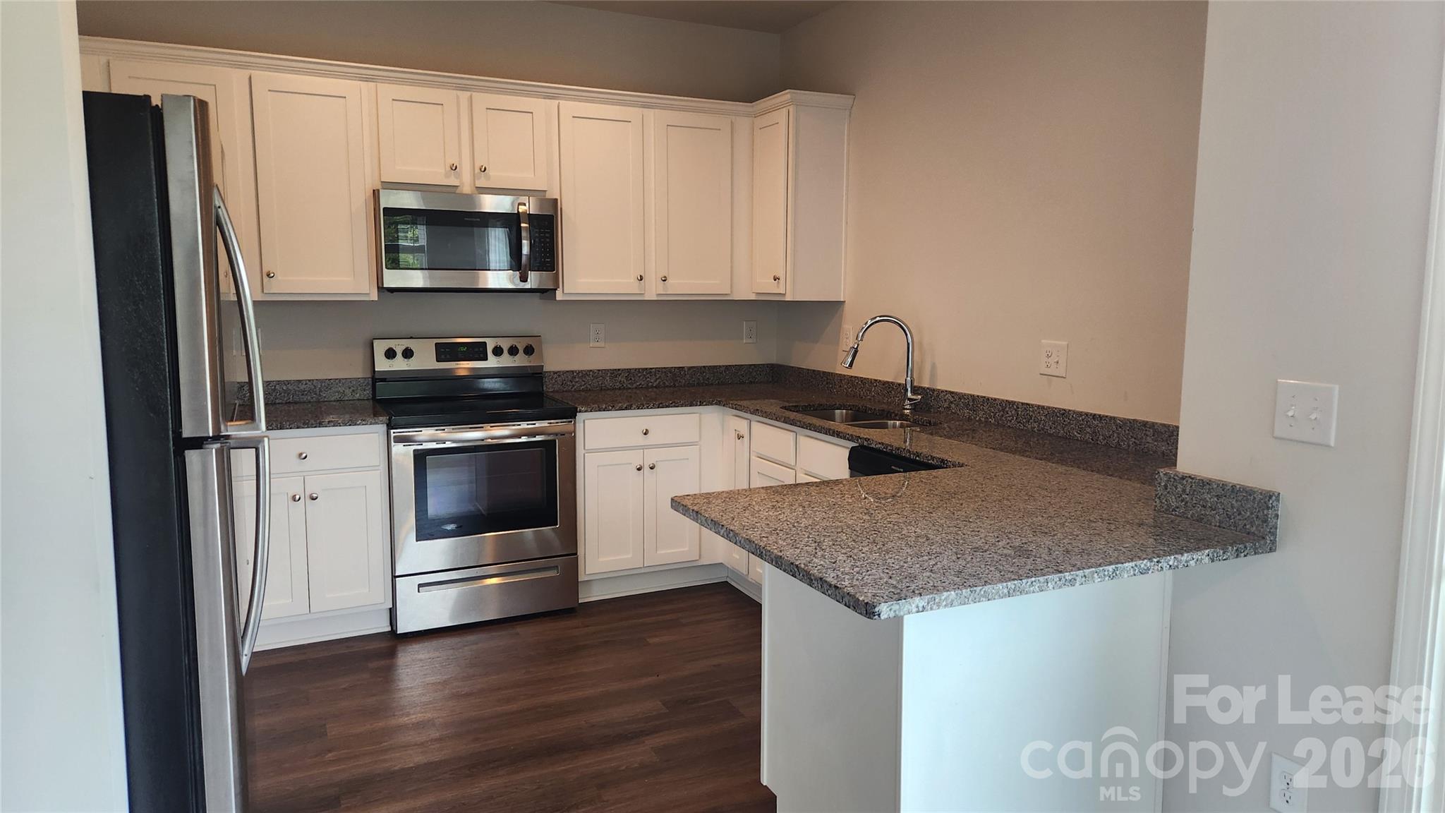 14320 Moss Road Charlotte, NC 28273 - Photo 5 of 22 a kitchen with stainless steel appliances granite countertop a sink stove and microwave