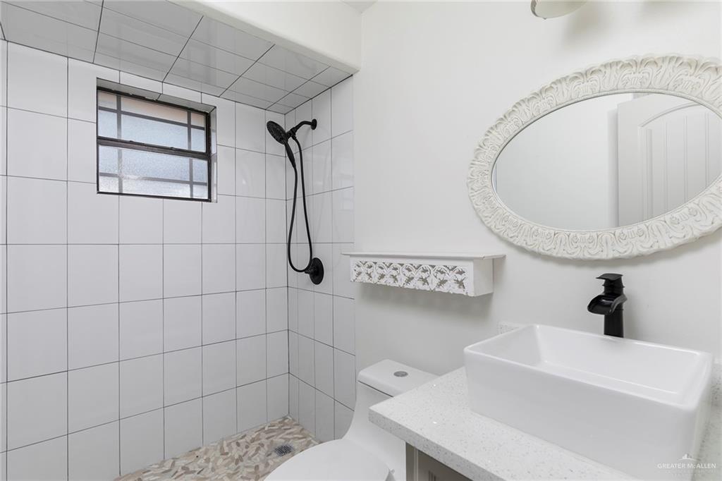 706 South 19th Street Hidalgo, TX 78557 - Photo 14 of 18 a bathroom with a sink a toilet and shower