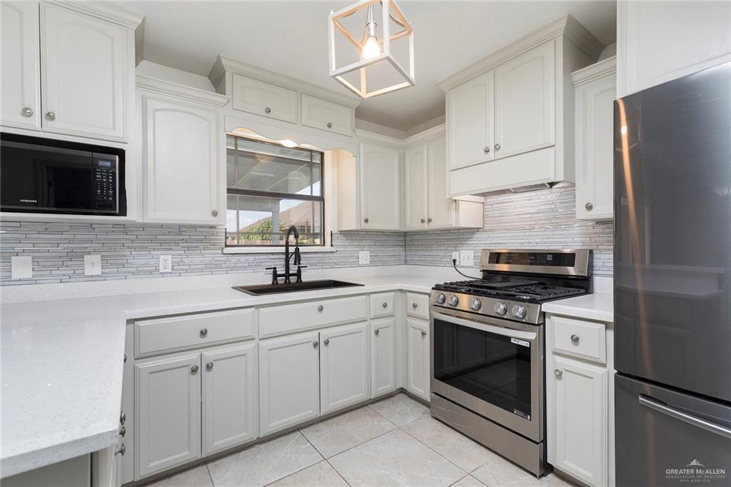 706 South 19th Street Hidalgo, TX 78557 - Photo 3 of 18 a kitchen with cabinets stainless steel appliances a sink and a counter space