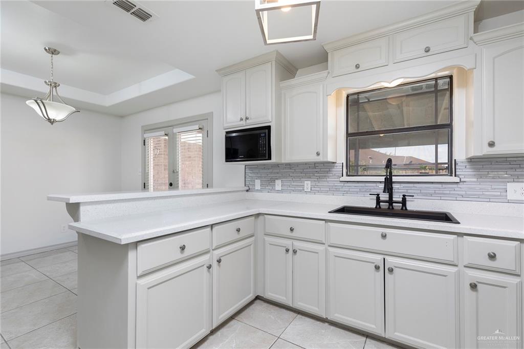 706 South 19th Street Hidalgo, TX 78557 - Photo 4 of 18 a kitchen with white cabinets appliances and sink