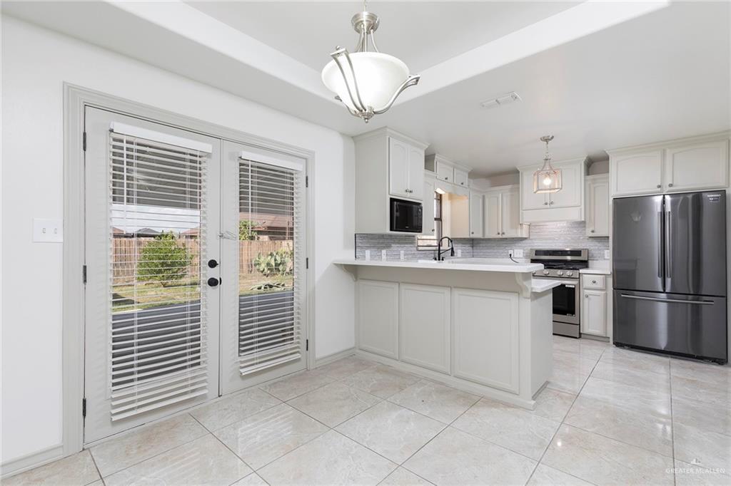 706 South 19th Street Hidalgo, TX 78557 - Photo 5 of 18 a kitchen with white cabinets and white appliances