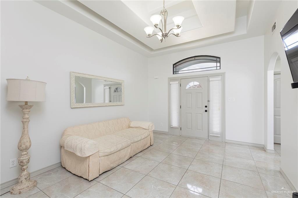 706 South 19th Street Hidalgo, TX 78557 - Photo 6 of 18 a spacious bedroom with a bed and a chandelier