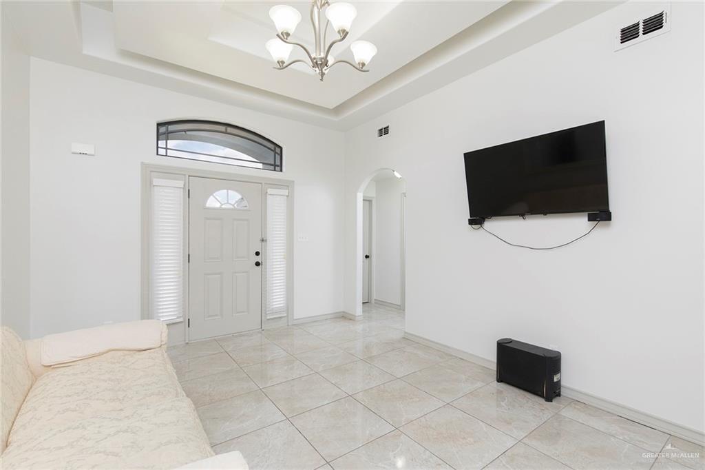 706 South 19th Street Hidalgo, TX 78557 - Photo 8 of 18 a view of a livingroom with a chandelier fan and windows