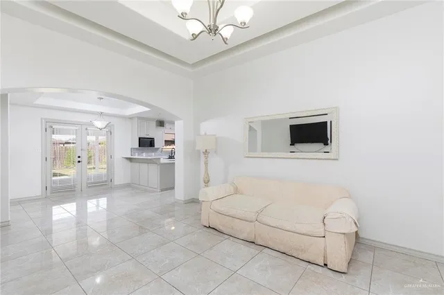 a living room with furniture and a kitchen view