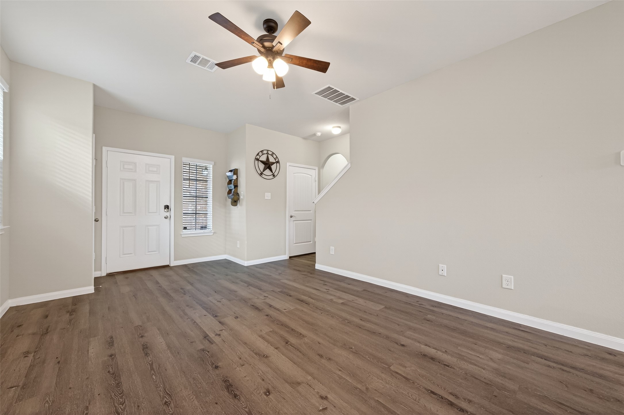 2354 Raider Drive Conroe, TX 77301 - Photo 3 of 20 an empty room with wooden floor ceiling fan and window