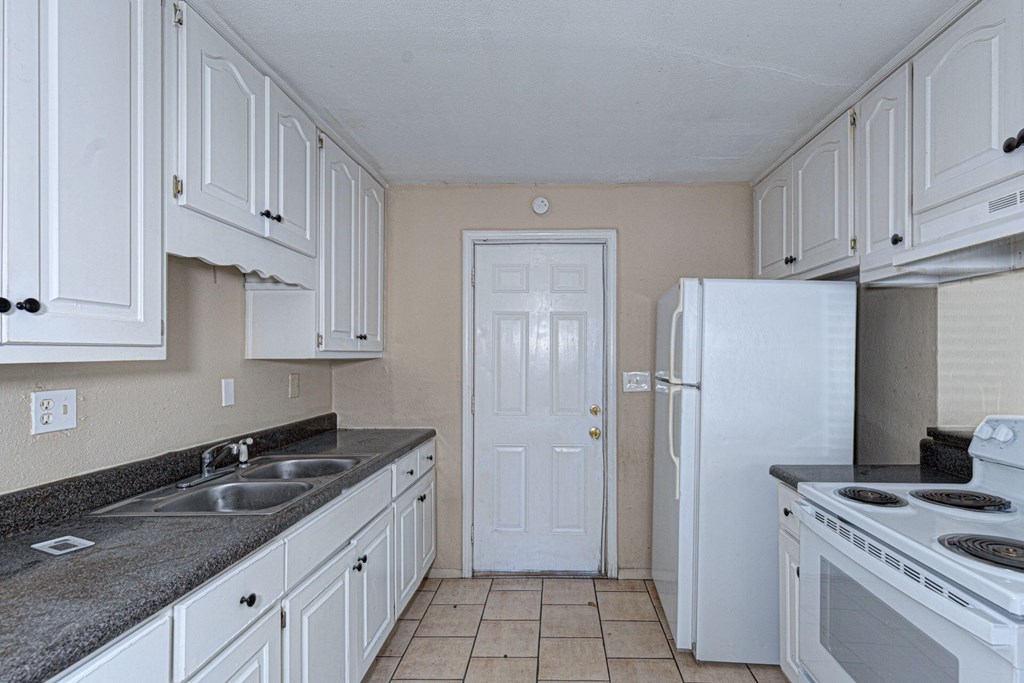 2946 Gleason Avenue Columbus, GA 31907 - Photo 5 of 17 a kitchen with white cabinets and appliances