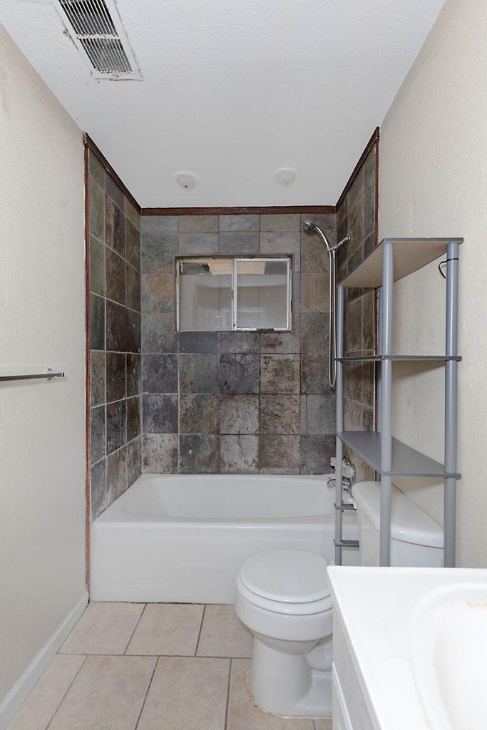 2946 Gleason Avenue Columbus, GA 31907 - Photo 6 of 17 a bathroom with a bathtub a toilet and a shower