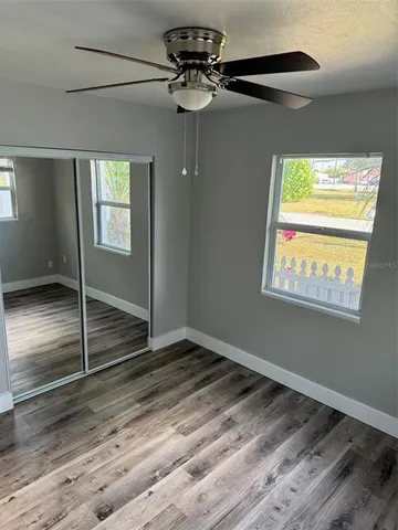 a view of room with window and ceiling fan