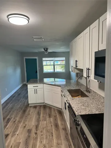 a kitchen with stainless steel appliances granite countertop a stove and a sink
