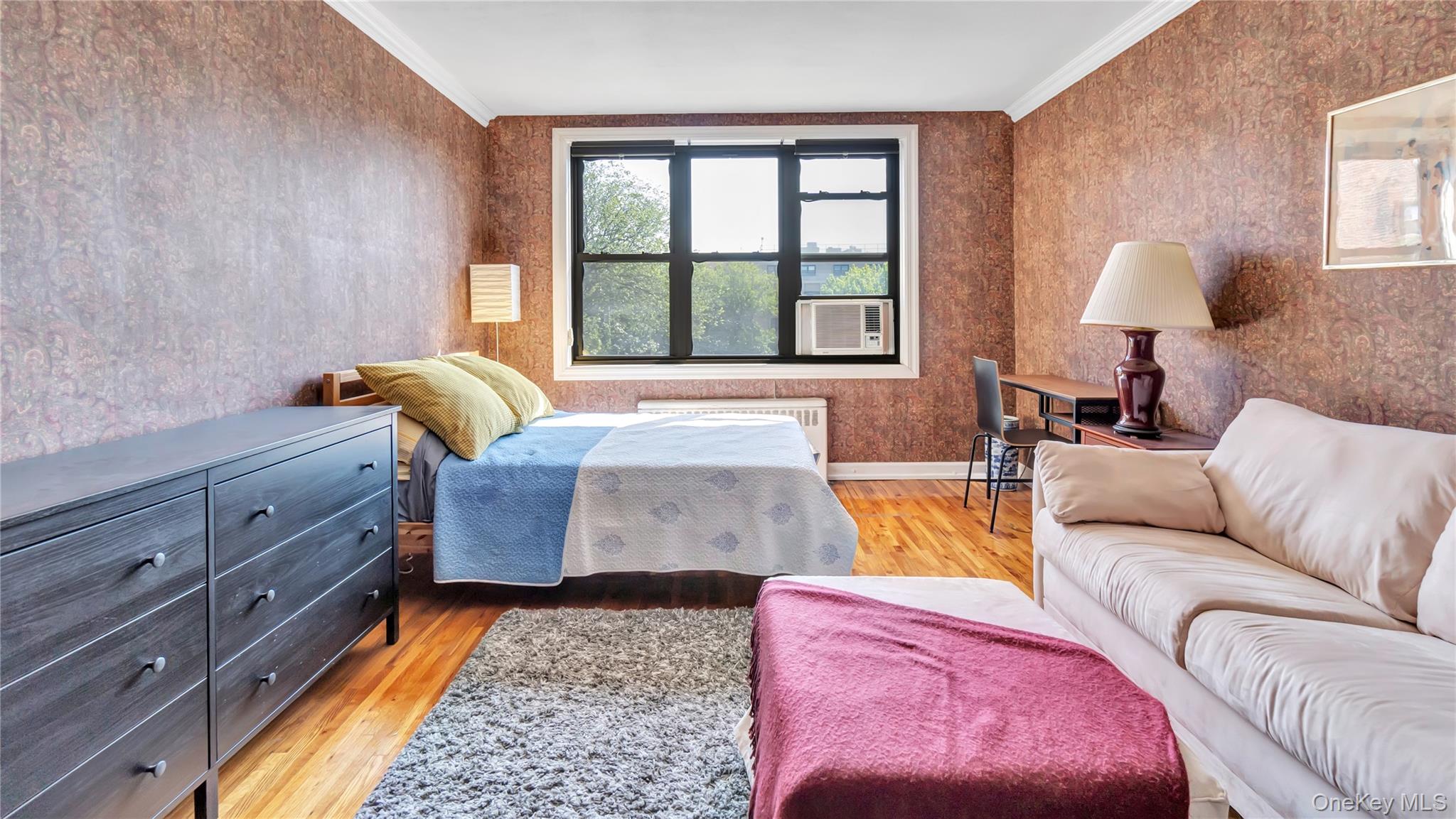 15 Canterbury Road, Unit D18 Great Neck, NY 11021 - Photo 2 of 10 Bedroom featuring light wood-style flooring, crown molding, and wallpapered walls