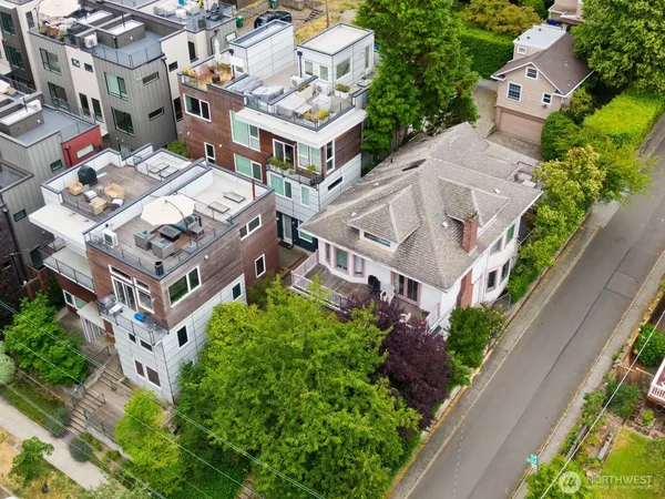 an aerial view of multiple houses with a yard