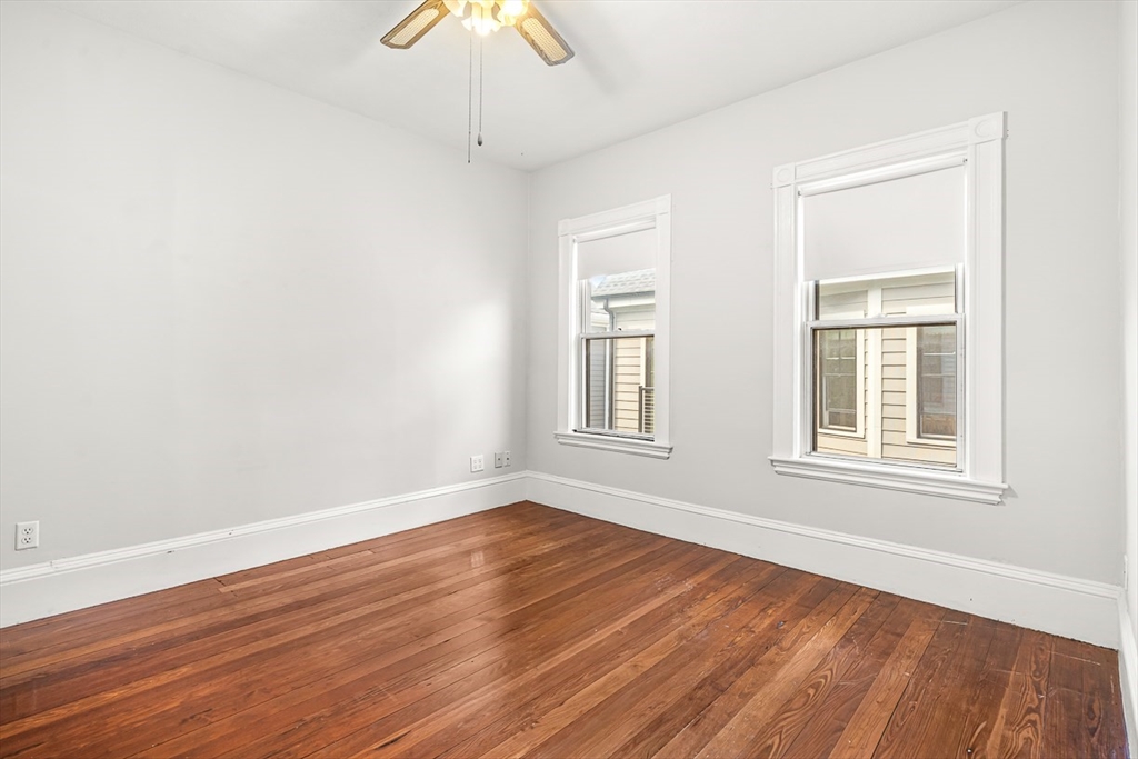 36 Windsor Road, Unit 2 Somerville, MA 02144 - Photo 20 of 26 a view of an empty room with wooden floor and a window
