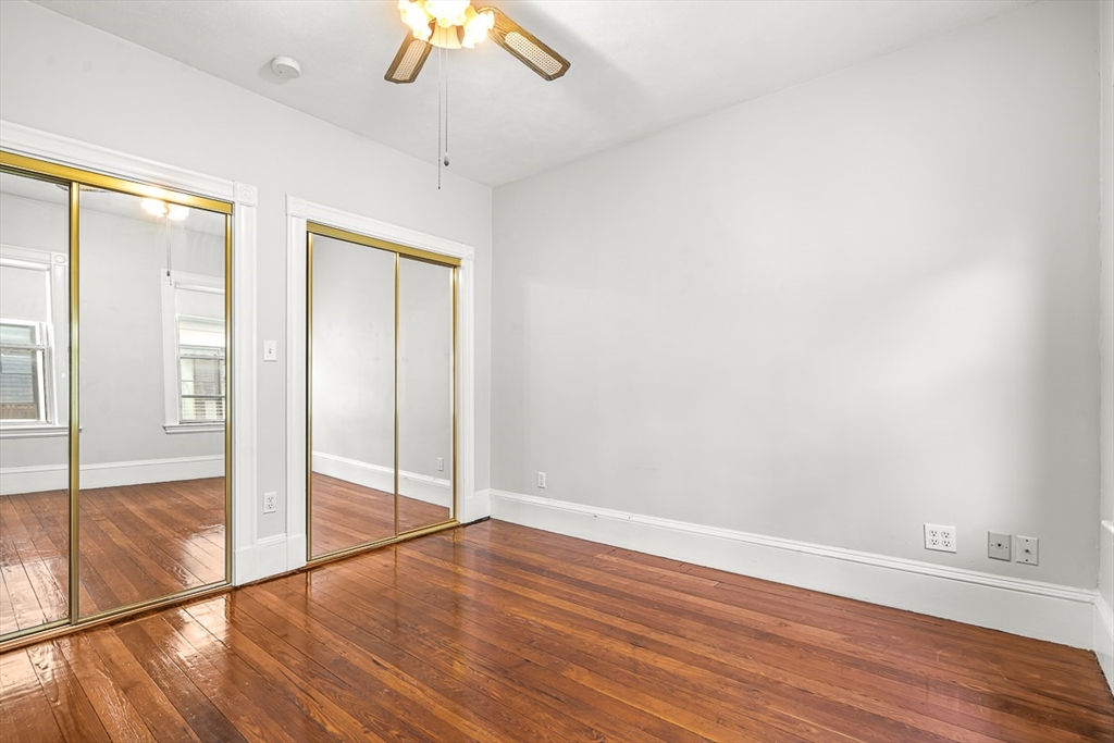 36 Windsor Road, Unit 2 Somerville, MA 02144 - Photo 22 of 26 wooden floor in an empty room with a window