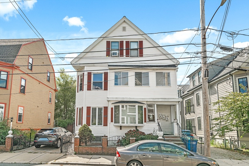 36 Windsor Road, Unit 2 Somerville, MA 02144 - Photo 25 of 26 a front view of a house with a yard