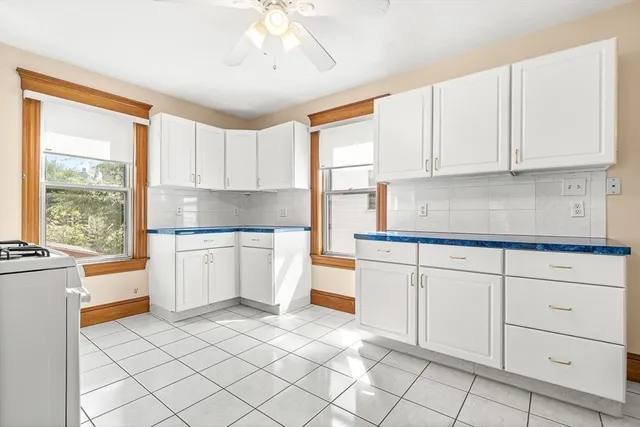 a kitchen with white cabinets and white appliances