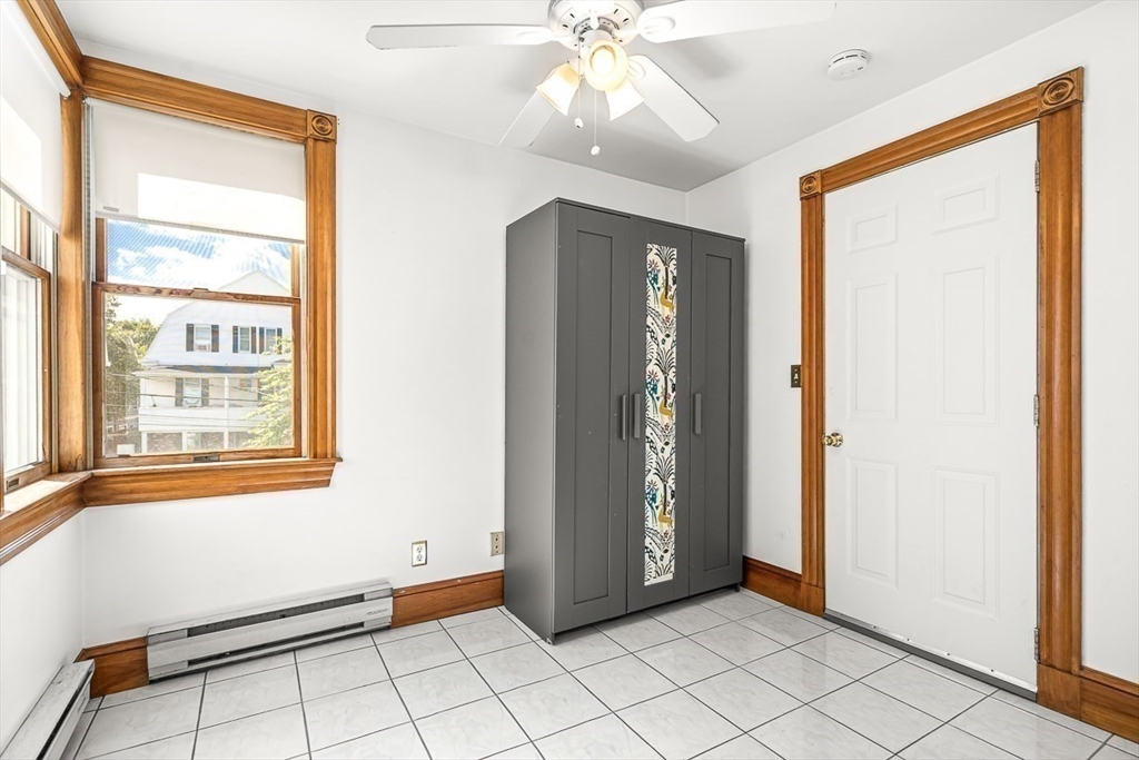 36 Windsor Road, Unit 2 Somerville, MA 02144 - Photo 10 of 26 a view of an empty room with window and chandelier fan